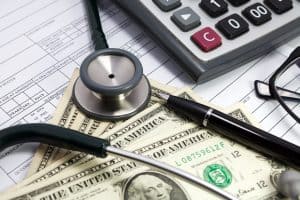 Pen stethoscope glasses and dollar on blank Patient information